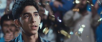 Movie still from “Slumdog Millionaire” (2008), directed by Danny Boyle – A young man is looking into the distance; Close Up shot, Low angle