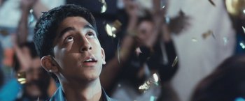 Movie still from “Slumdog Millionaire” (2008), directed by Danny Boyle – A young man looking up into the sky; Close Up shot, Low angle