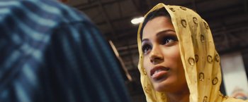 Movie still from “Slumdog Millionaire” (2008), directed by Danny Boyle – A person wearing a head scarf; Close Up shot, Over the shoulder angle