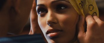 Movie still from “Slumdog Millionaire” (2008), directed by Danny Boyle – A woman's face with dark eye makeup; Close Up shot, Over the shoulder angle