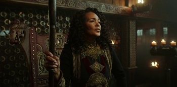 Movie still from “Vikings: Valhalla” (2022), created by Jeb Stuart – A woman holding a pole in a dark room; Close Up shot, Over the shoulder angle