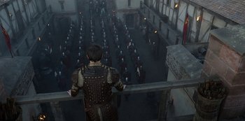 Movie still from “Vikings: Valhalla” (2022), created by Jeb Stuart – A man standing in front of a group of people; Extreme Wide shot, High angle