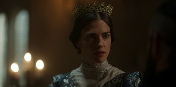 Movie still from “Vikings: Valhalla” (2022), created by Jeb Stuart – A woman wearing a crown in a dark room; Close Up shot, Over the shoulder angle