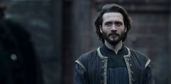 Movie still from “Vikings: Valhalla” (2022), created by Jeb Stuart – A man with long hair and a beard wearing medieval clothing; Close Up shot, Low angle