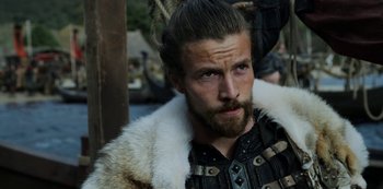Movie still from “Vikings: Valhalla” (2022), created by Jeb Stuart – A person with a beard; Close Up shot, Over the shoulder angle