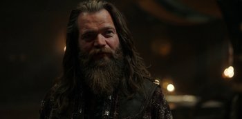 Movie still from “Vikings: Valhalla” (2022), created by Jeb Stuart – A man with long hair and a long beard; Close Up shot, Low angle