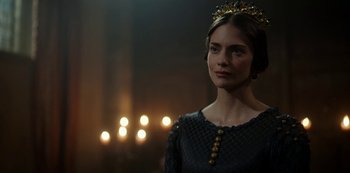 Movie still from “Vikings: Valhalla” (2022), created by Jeb Stuart – A woman wearing a crown standing in a dark room; Close Up shot, Over the shoulder angle