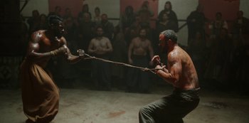 Movie still from “Vikings: Valhalla” (2022), created by Jeb Stuart – Two men are competing in a tug of war competition; Medium shot, Over the shoulder angle