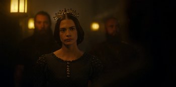 Movie still from “Vikings: Valhalla” (2022), created by Jeb Stuart – A woman wearing a crown standing in front of two men; Close Up shot, Over the shoulder angle