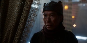 Movie still from “Vikings: Valhalla” (2022), created by Jeb Stuart – A man wearing a hat and a leather jacket; Close Up shot, Low angle