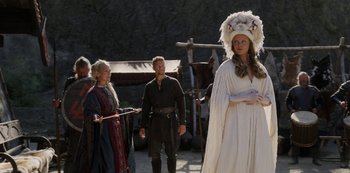 Movie still from “Vikings: Valhalla” (2022), created by Jeb Stuart – A man and a woman dressed in medieval garb; Medium shot, Over the shoulder angle