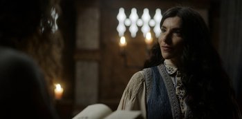 Movie still from “Vikings: Valhalla” (2022), created by Jeb Stuart – A woman is looking at a book in a dark room; Close Up shot, Over the shoulder angle