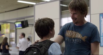 Movie still from “Before Midnight” (2013), directed by Richard Linklater – A man and a boy are talking to each other; Medium shot, Over the shoulder angle