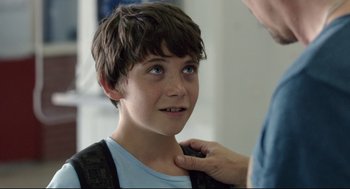 Movie still from “Before Midnight” (2013), directed by Richard Linklater – A young boy is being examined by a doctor; Close Up shot, Over the shoulder angle
