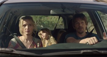 Movie still from “Before Midnight” (2013), directed by Richard Linklater – A woman and a man and a girl in a car; Medium shot, Over the shoulder angle