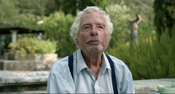Movie still from “Before Midnight” (2013), directed by Richard Linklater – An older man with white hair wearing a shirt and suspenders; Close Up shot, Low angle