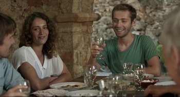 Movie still from “Before Midnight” (2013), directed by Richard Linklater – A man and a woman sitting at a table with wine glasses; Medium shot, Over the shoulder angle