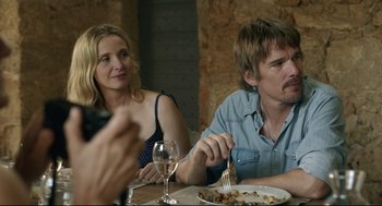 Movie still from “Before Midnight” (2013), directed by Richard Linklater – A man and a woman sitting at a table with a plate of food; Medium shot, Over the shoulder angle