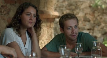 Movie still from “Before Midnight” (2013), directed by Richard Linklater – A man and a woman sitting next to each other at a table; Close Up shot, Over the shoulder angle