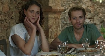 Movie still from “Before Midnight” (2013), directed by Richard Linklater – A man and a woman sitting at a table with plates of food on it; Close Up shot, Over the shoulder angle