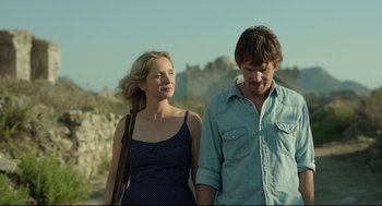 Movie still from “Before Midnight” (2013), directed by Richard Linklater – A man and a woman are walking together; Medium shot, Low angle