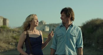 Movie still from “Before Midnight” (2013), directed by Richard Linklater – A man and a woman standing next to each other on the side of a road; Medium shot, Over the shoulder angle