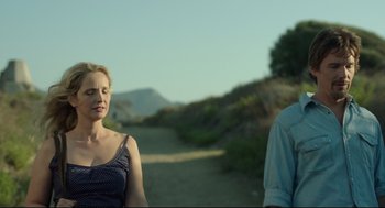 Movie still from “Before Midnight” (2013), directed by Richard Linklater – A woman and a man standing next to each other on a dirt road; Close Up shot, Over the shoulder angle
