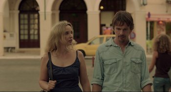 Movie still from “Before Midnight” (2013), directed by Richard Linklater – A man and a woman walking down a street; Medium shot, Over the shoulder angle