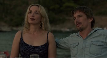 Movie still from “Before Midnight” (2013), directed by Richard Linklater – A man and a woman standing next to a body of water; Close Up shot, Low angle