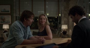 Movie still from “Before Midnight” (2013), directed by Richard Linklater – A man and a woman sitting at a wooden table; Medium shot, Over the shoulder angle