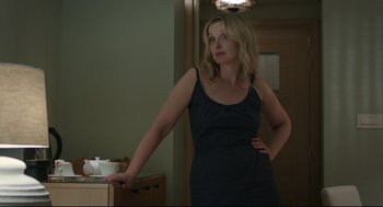 Movie still from “Before Midnight” (2013), directed by Richard Linklater – A woman standing in front of a table with a bowl on top of it; Medium shot, Over the shoulder angle