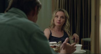 Movie still from “Before Midnight” (2013), directed by Richard Linklater – A woman sitting at a table with a man in front of her; Close Up shot, Over the shoulder angle