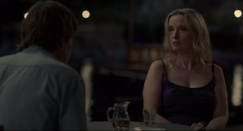Movie still from “Before Midnight” (2013), directed by Richard Linklater – A woman sitting at a table in front of a man; Medium shot, Over the shoulder angle