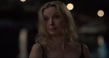 Movie still from “Before Midnight” (2013), directed by Richard Linklater – A woman with long blonde hair is looking at the camera; Close Up shot, Over the shoulder angle