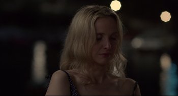 Movie still from “Before Midnight” (2013), directed by Richard Linklater – A woman with long blonde hair wearing a polka dot top; Close Up shot, Over the shoulder angle