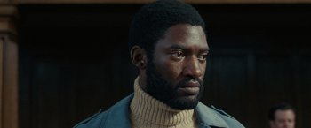 Movie still from “Small Axe” (2020), directed by Steve McQueen – A person wearing a sweater; Close Up shot, Low angle