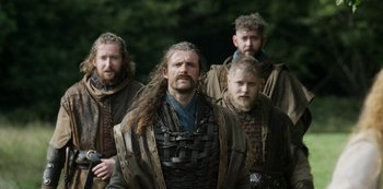 Movie still from “Vikings: Valhalla” (2022), created by Jeb Stuart – A group of men standing next to each other; Medium shot, Low angle