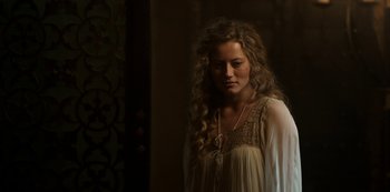 Movie still from “Vikings: Valhalla” (2022), created by Jeb Stuart – A woman with long curly hair standing in a room; Close Up shot, Over the shoulder angle