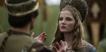 Movie still from “Vikings: Valhalla” (2022), created by Jeb Stuart – A woman wearing a crown talking to a man; Close Up shot, Over the shoulder angle