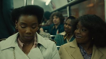 Movie still from “Small Axe” (2020), directed by Steve McQueen – Two women are sitting on a subway train; Close Up shot, Over the shoulder angle