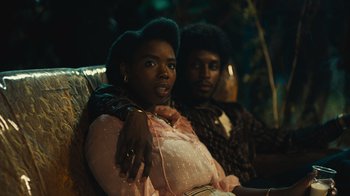 Movie still from “Small Axe” (2020), directed by Steve McQueen – A woman sitting next to a man on a couch; Close Up shot, Low angle
