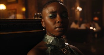 Movie still from “Wednesday” (2022), created by Miles Millar – A person wearing a necklace; Close Up shot, Over the shoulder angle