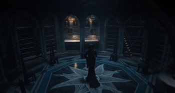 Movie still from “Wednesday” (2022), created by Miles Millar – A woman standing in the middle of a room; Wide shot, High angle