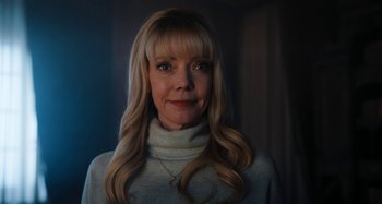 Movie still from “Wednesday” (2022), created by Miles Millar – A woman with blonde hair wearing a white sweater; Close Up shot, Low angle