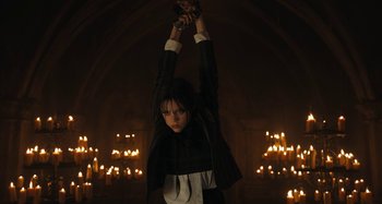 Movie still from “Wednesday” (2022), created by Miles Millar – Medium shot, Low angle