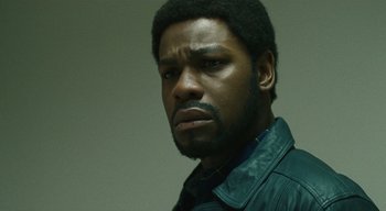 Movie still from “Small Axe” (2020), directed by Steve McQueen – A person wearing a leather jacket; Close Up shot, Low angle