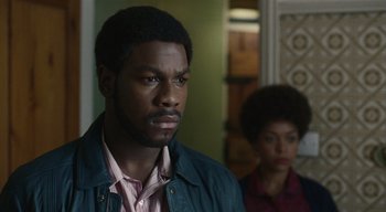 Movie still from “Small Axe” (2020), directed by Steve McQueen – A man and a woman standing next to each other in a room; Close Up shot, Over the shoulder angle
