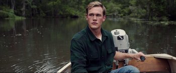 A man sitting in a boat on a river