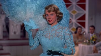 Movie still from “White Christmas” (1954), directed by Michael Curtiz – A woman in a blue dress holding a fan; Medium shot, Low angle