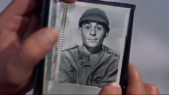 Movie still from “White Christmas” (1954), directed by Michael Curtiz – An old photo of a man wearing a military uniform; Extreme Close Up shot, Over the shoulder angle
